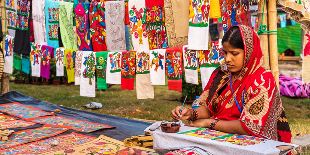 Woman painting traditional fabric
